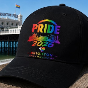 May include: Black baseball cap featuring a rainbow Pride design. The design includes the text "PRIDE 2026 BRIGHTON" with a rainbow heart and a rainbow arch. The cap also has the words "LOVE | PRIDE | FUTURE" in a thin line.