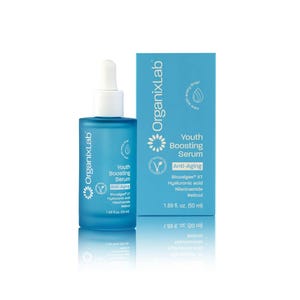 May include: A blue glass bottle of OrganixLab Youth Boosting Serum with a white dropper, next to a matching box. The box and bottle feature the text "Anti-Aging" and list ingredients. The bottle contains 1.69 fl. oz. (50 ml).