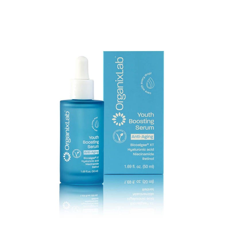 May include: A blue glass bottle of OrganixLab Youth Boosting Serum with a white dropper, next to a matching box. The box and bottle feature the text "Anti-Aging" and list ingredients. The bottle contains 1.69 fl. oz. (50 ml).