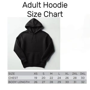 May include: A black adult hoodie with a hood and a front pocket. The image includes a size chart with chest measurements ranging from 19 to 30 inches and body lengths from 26 to 32 inches. The text "Adult Hoodie Size Chart" is at the top.