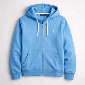 May include: A light blue zip-up hoodie with a drawstring hood and a kangaroo pocket. The hoodie features a white embroidered logo on the chest and a white zipper. The garment is made of a soft, comfortable material.