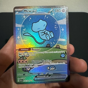 May include: A holographic Mew ex Pokémon trading card. The card features a blue Mew character with a light blue background and a rainbow holographic effect. The card has text describing its abilities and stats.
