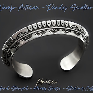 May include: A sterling silver cuff bracelet with intricate hand-stamped designs. The bracelet features a series of repeating patterns and the text "Navajo Artisan - Randy Secatero". The cuff is labeled "Unisex" and "Hand Stamped - Heavy Gauge - Sterling Cuff".