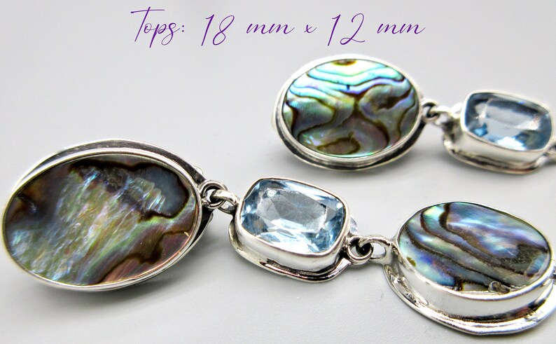 May include: A pair of silver earrings with oval-shaped abalone shell and blue topaz stones. Tops: 18 mm x 12 mm.