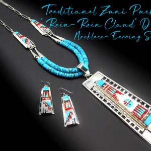 May include: A silver necklace and earring set with a turquoise and red "Rain-Rain Cloud" design. The necklace has a long rectangular pendant and a double strand of turquoise beads. The earrings are small, matching pendants.