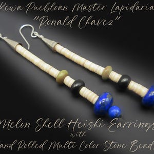 May include: Long dangle earrings featuring cream-colored melon shell heishi beads, accented with olive green, black, and vibrant blue lapis lazuli stone beads. The earrings include silver-toned metal cones and hooks. Text reads: Kewa Puebloan Master Lapidarian Ronald Chavez, Melon Shell Heishi Earrings with Hand Rolled Multi Color Stone Beads.