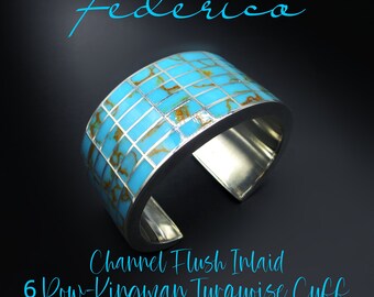 May include: A silver cuff bracelet with a channel flush inlay of turquoise stones. The turquoise is a Kingman turquoise and is set in a six-row pattern. The bracelet is a statement piece and would be a great addition to any jewelry collection.