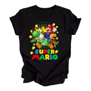 May include: A black short-sleeved t-shirt featuring a graphic print of Mario riding Yoshi. The design includes yellow stars, gold coins, and comic-style text bubbles with the words WOW, SUPER, and BOOM, along with the text SUPER MARIO in large letters.