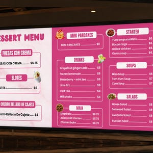May include: A digital menu board with a pink and white background featuring sections for Dessert Menu, Mini Pancakes, Starter, Drinks, Soups, Main, and Salads. The text lists various food and drink items with prices in dollars, accompanied by small food images.