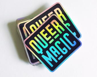 May include: A stack of rainbow holographic stickers with the text "QUEER MAGIC" in black.