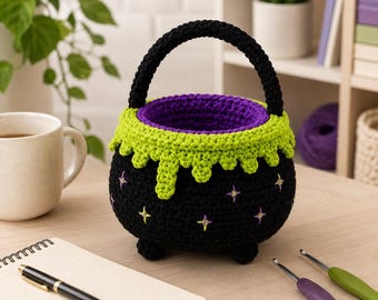 May include: A round, black crocheted basket shaped like a cauldron with a handle. It features a bright lime green scalloped rim, a purple interior lining, and small embroidered star-shaped accents in yellow and purple on the exterior surface.