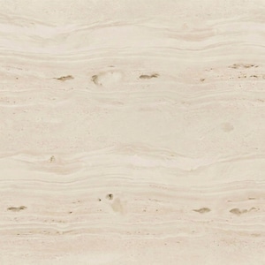 May include: A close-up of a beige stone surface with a natural, layered pattern. The stone has subtle variations in color and texture, with small, dark spots scattered throughout. The overall appearance is smooth and organic.