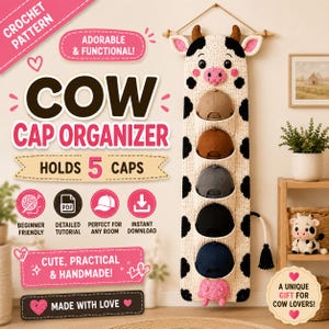 May include: A crochet pattern for a wall-hanging cow cap organiser that holds 5 caps. The organiser is cream-coloured with black spots, featuring a cow head at the top and a tail at the bottom. Text includes "CROCHET PATTERN", "COW CAP ORGANISER", "HOLDS 5 CAPS", "BEGINNER FRIENDLY", "DETAILED TUTORIAL", "PERFECT FOR ANY ROOM", "INSTANT DOWNLOAD", "CUTE, PRACTICAL & HANDMADE!", "MADE WITH LOVE", and "A UNIQUE GIFT FOR COW LOVERS!".