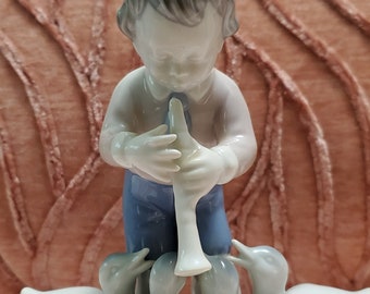 Boy Playing Flute with Ducks