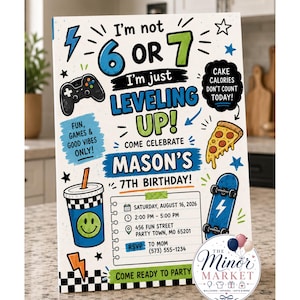 May include: A rectangular birthday invitation card featuring the text I'm not 6 or 7 I'm just LEVELING UP! COME CELEBRATE MASON'S 7TH BIRTHDAY! with graphics of a game controller, pizza slice, drink cup, and skateboard on a white background.