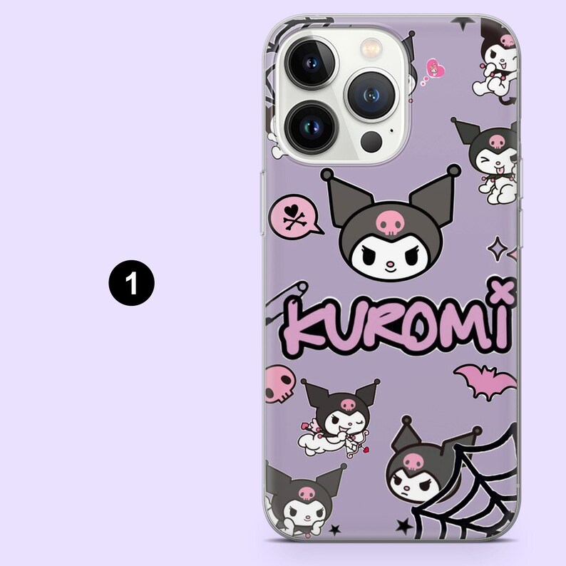 May include: A lilac phone case with a cartoon Kuromi design. The case has a clear border and features the name "Kuromi" in pink, along with illustrations of skulls, bats, and spiderwebs. The case is designed for a smartphone.