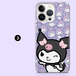 May include: Transparent phone case with a cartoon character design. The character has a black head, pink bows, and a skull. The case has a purple background with a repeating pattern of the same character. The number "3" is in a black circle.