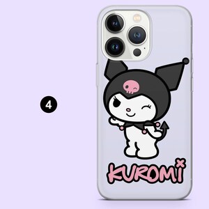 May include: Transparent phone case with a cartoon character in a black hood, skull, and devil tail. The character is winking, and the word "KUROMI" is in pink. The case is set against a light purple backdrop.
