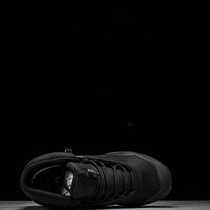 May include: Black athletic shoe with a mesh upper and a thick sole. The shoe features a lace-up design and a padded collar. The shoe is designed for outdoor activities and is suitable for various terrains.