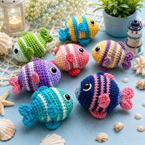 May include: A collection of six small, round, crocheted fish toys, each featuring horizontal stripes in various color combinations including blue, yellow, green, pink, and purple, with black plastic eyes and small crocheted fins and tails.