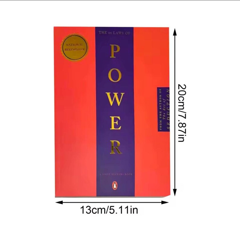 May include: A hardback book titled "The 48 Laws of Power", measuring 13cm wide and 20cm tall. The cover is red with a purple central stripe, displaying the title in gold. A gold seal indicates "National Bestseller".