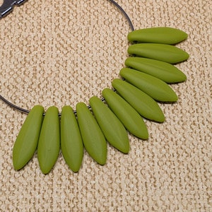 May include: A pair of green dangle earrings with a silver hoop and a cluster of green teardrop-shaped beads.