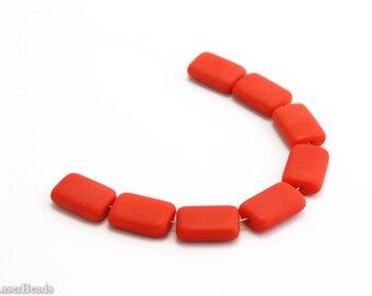 May include: A strand of ten bright red rectangular glass beads. The beads are arranged in a semi-circle shape.