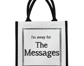 May include: A white tote bag with black trim and handles. The bag features the text "I'm away for The Messages" in a black, bold font, framed by a black border. The bag is designed for carrying items.