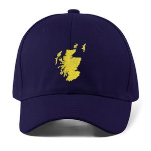 May include: A navy blue baseball cap with an embroidered yellow outline of the country of Scotland.
