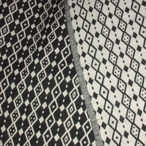 May include: Black and white fabric with a diamond pattern. The fabric is woven with a textured surface.