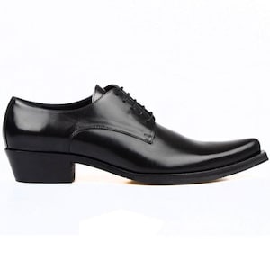 Könnte beinhalten: Ein schwarzer Oxford-Schuh aus Leder mit polierter Oberfläche, spitzer Zehenpartie, einem geschichteten Blockabsatz und schwarzen Schnürsenkeln. Der Schuh hat eine schlanke Silhouette mit sichtbaren Nähten an den Seitenteilen und einer stabilen Sohle.