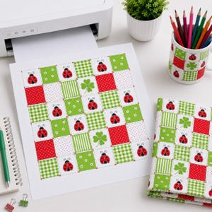 May include: A printed sheet and a matching fabric piece featuring a grid pattern of red and green squares. The design includes ladybugs, white flowers, green clovers, and various patterns like gingham, polka dots, and stripes in red and green.