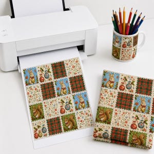 May include: A white printer, a mug filled with colored pencils, and a folded fabric square, all featuring a repeating pattern of squirrels, rabbits, floral motifs, and Christmas ornaments in red, green, blue, and cream colors.