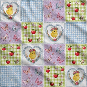 May include: A fabric pattern featuring a grid of squares with alternating designs of yellow chicks inside floral hearts, blue gingham with white stars, purple with butterflies, and green gingham with red apples and small white flowers.