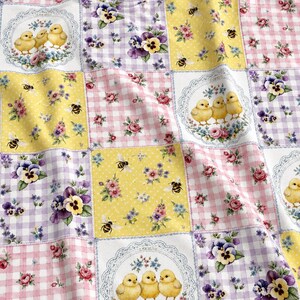 May include: Fabric featuring a patchwork pattern of squares with yellow, pink, and purple gingham, floral prints, and circular lace frames containing illustrations of three yellow chicks. The design includes bees and pansies throughout the fabric.