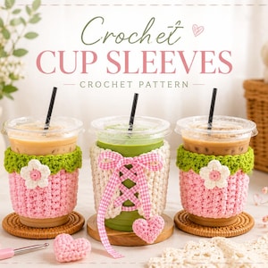 May include: Three clear plastic cups with black straws, each wearing a handmade crochet sleeve. Two sleeves are pink with green tops and white flower accents. The center sleeve is cream-colored with a pink gingham ribbon lace-up and heart charm.