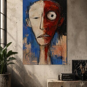 May include: A rectangular canvas painting featuring a stylized portrait with a face split into two distinct halves. The left side is pale cream, while the right side is deep red with a large, wide eye. The background is a vibrant blue with dark strokes.
