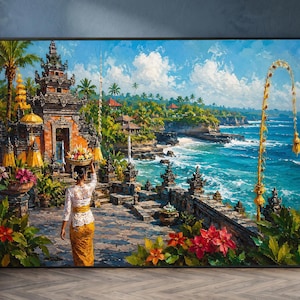 Puede incluir: Un cuadro rectangular enmarcado que representa una escena de un templo balinés en la costa. Una figura con vestimenta tradicional blanca y amarilla lleva una ofrenda sobre la cabeza cerca de una terraza de piedra frente al océano azul.