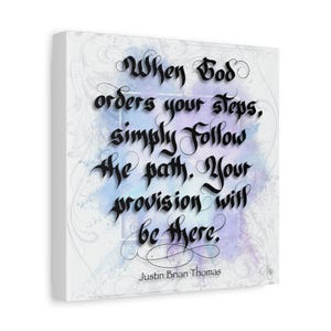 May include: A square canvas print featuring black gothic calligraphy text that reads: When God orders your steps, simply follow the path. Your provision will be there. The background has a light blue and purple watercolor wash effect.