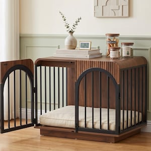 May include: A wooden dog crate with a dark walnut finish, featuring black metal vertical bars and an arched door design. The interior contains a thick, cream-colored rectangular cushion. The top surface is flat with rounded edges.