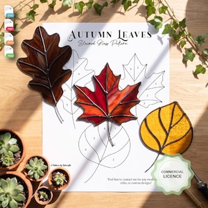 May include: A digital download document titled Autumn Leaves Stained Glass Pattern featuring three stained glass leaf ornaments in brown, red, and yellow, alongside their corresponding numbered line art templates for crafting projects.