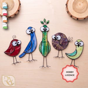 May include: Five stained glass bird figures with large white eyes and thin metal wire legs. The birds are red, blue, green, purple, and light green. A red scalloped badge in the bottom right corner contains the text HOBBY LICENCE.