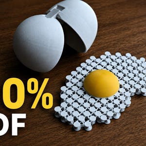 May include: A white 3D printed egg shell with a hinged top and a separate fried egg shape featuring a yellow center and a white lattice-style egg white. The text 10% OF is printed in yellow and white on the left side of the image.