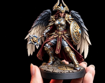 May include: A miniature figurine of a winged warrior wearing ornate silver and gold armor, a red cloak, and a horned helmet. The figure holds a spiked mace and a circular shield, standing on a cracked stone base with a circular metal emblem.