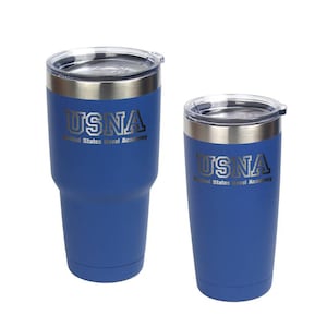 May include: Two blue insulated tumblers with silver rims and clear lids. The larger tumbler is wider at the base and tapers upward. Both tumblers feature the text "USNA United States Naval Academy" in silver lettering.