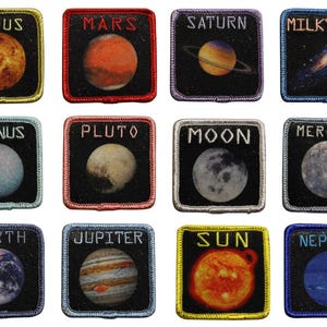 May include: Set of twelve embroidered patches featuring planets and celestial bodies. Each patch has a black background with a colorful image of a planet or galaxy, and the planet's name in white text. Includes Venus, Mars, Saturn, Milky Way, Uranus, Pluto, Moon, Mercury, Earth, Jupiter, Sun, and Neptune.