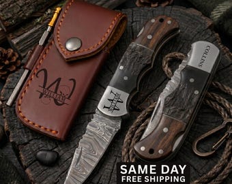 May include: A brown leather sheath with the name William engraved, a folding knife with a Damascus steel blade and wood handle engraved with William, and a second folding knife with a wood handle engraved with the name Collins.