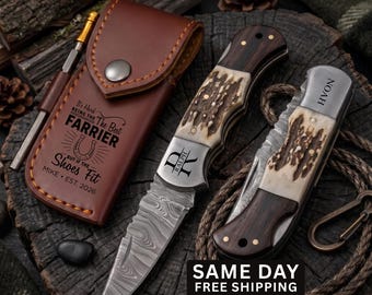 May include: A brown leather sheath with a metal snap closure, a metal pen, and two folding pocket knives with textured antler and dark wood handles. The sheath features the text It's Hard BEING THE Best FARRIER BUT IF THE SHOES FIT MIKE EST. 2026.