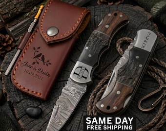 May include: Two folding knives with Damascus steel blades and dark wood handles, one featuring the name Parker and the other the name Dustin. A brown leather sheath is engraved with the text Jane & Dustin 10.09.2021 and a bird design.