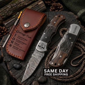 May include: A brown leather sheath with a metal snap and engraved religious text, a folding knife with a Damascus steel blade and wood handle engraved with the name Ethan, and a second folding knife with the name Smith engraved on the bolster.